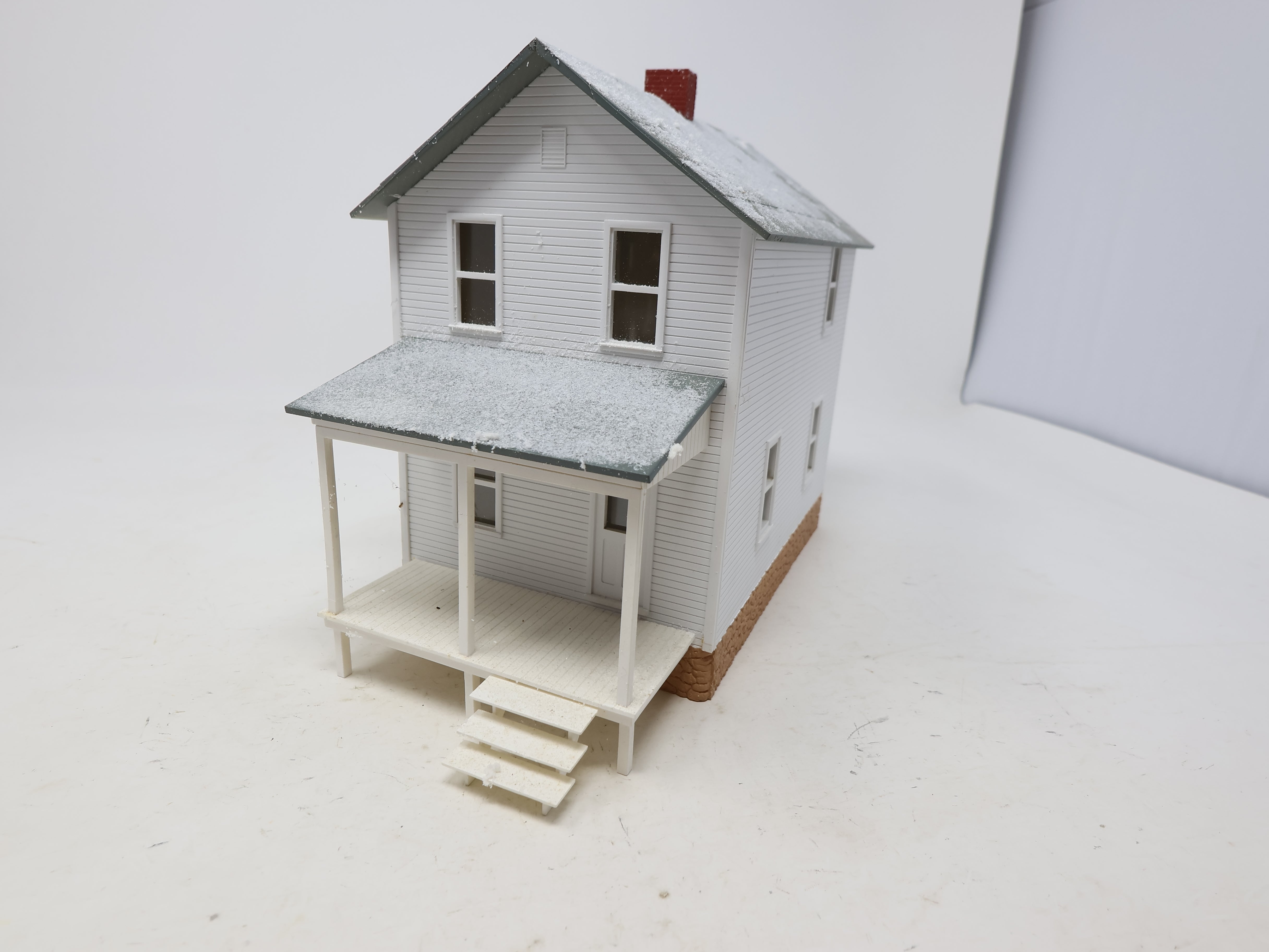 USED O, White Home w/ Gray Roof & Snow